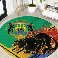 Green round rug with black panther, Gabon crest, and flame accents