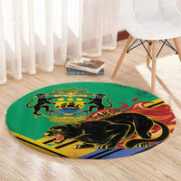 Green round rug with black panther and Gabon emblem, angled view