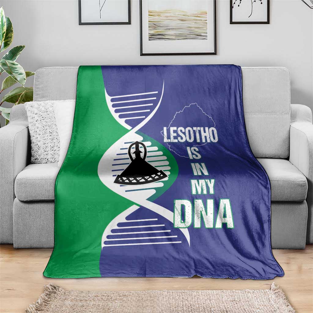 Lesotho DNA blanket in blue and green with emblem and map print, spread over sofa