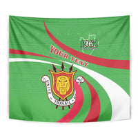 Green tapestry close-up with 1962, crest emblem, and red/white curved stripes design