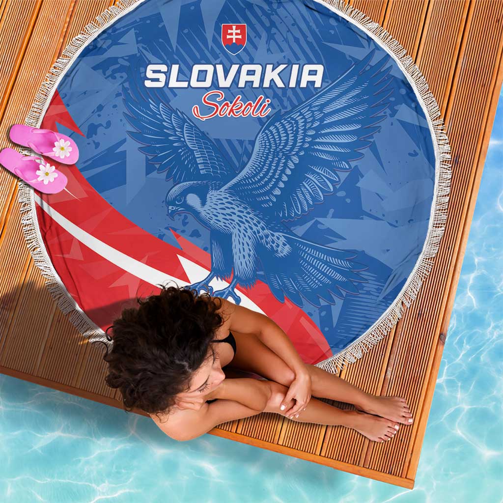 Round Slovakia beach blanket, blue eagle emblem with red/white diagonal stripe, tassel fringe.