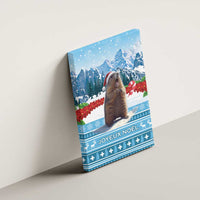 Blue canvas wall art of a marmot in a Santa hat on a snowy winter scene