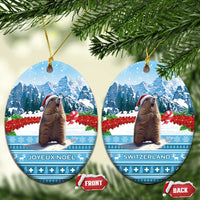 Oval blue ceramic Christmas ornament with marmot, Swiss mountains, front and back