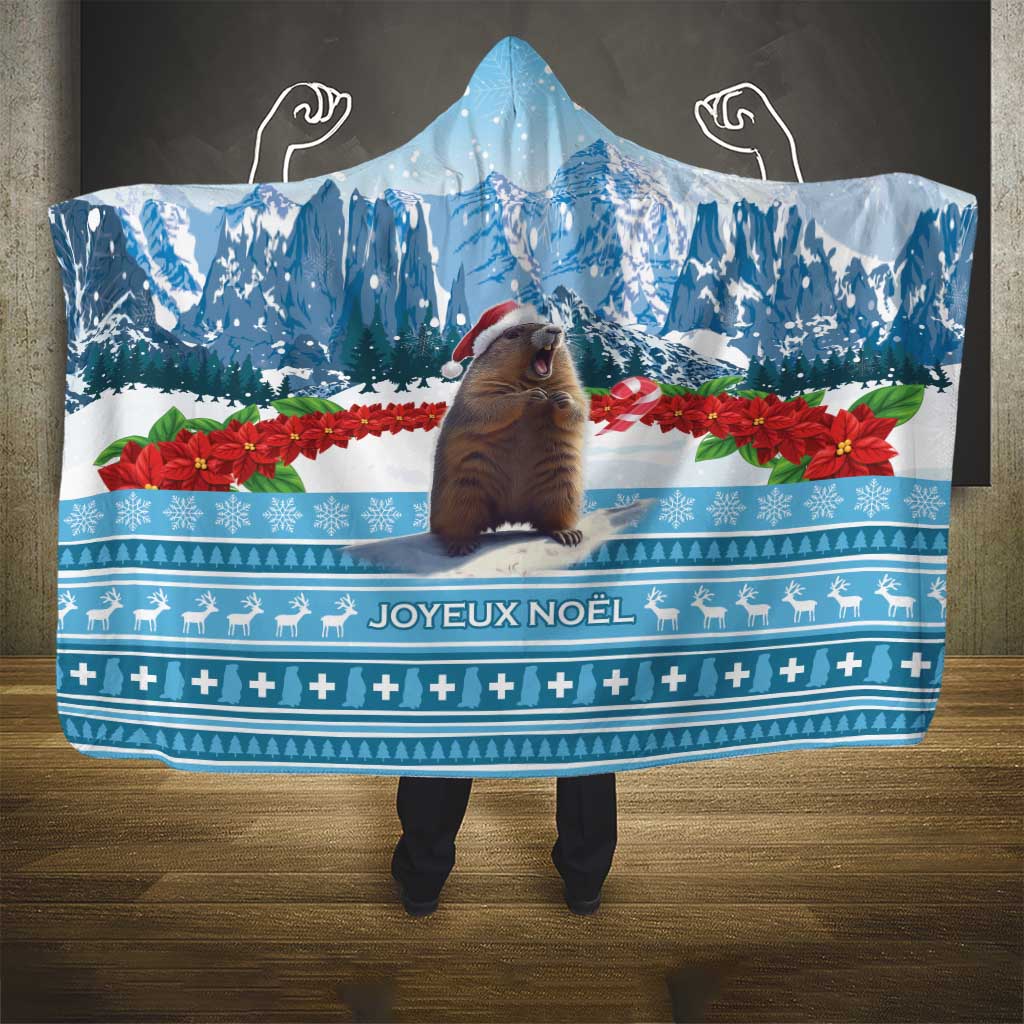 Blue hooded blanket with winter landscape, poinsettias, and Joyeux Noel border pattern