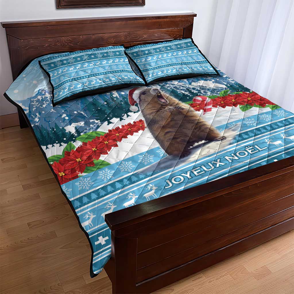 Blue Christmas quilt bed set with marmot, poinsettias, and JOYEUX NOEL text, plus 2 pillows