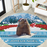 Round blue Christmas area rug with illustrated marmot and "Joyeux Noel" text