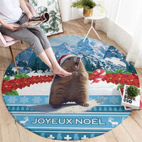 Round blue Christmas area rug with marmot illustration and "Joyeux Noel" on the floor