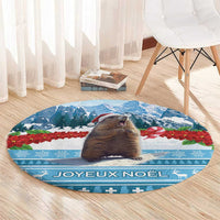 Round blue Christmas area rug with centered marmot, poinsettias, and "Joyeux Noel" lettering