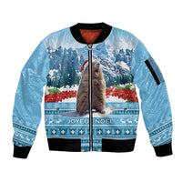 Blue zip-up bomber jacket with ribbed cuffs and holiday landscape graphic with marmot