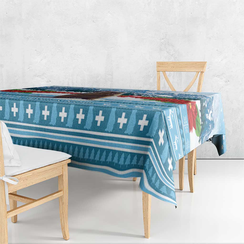Blue Christmas tablecloth with cross-and-arrow border and winter motifs