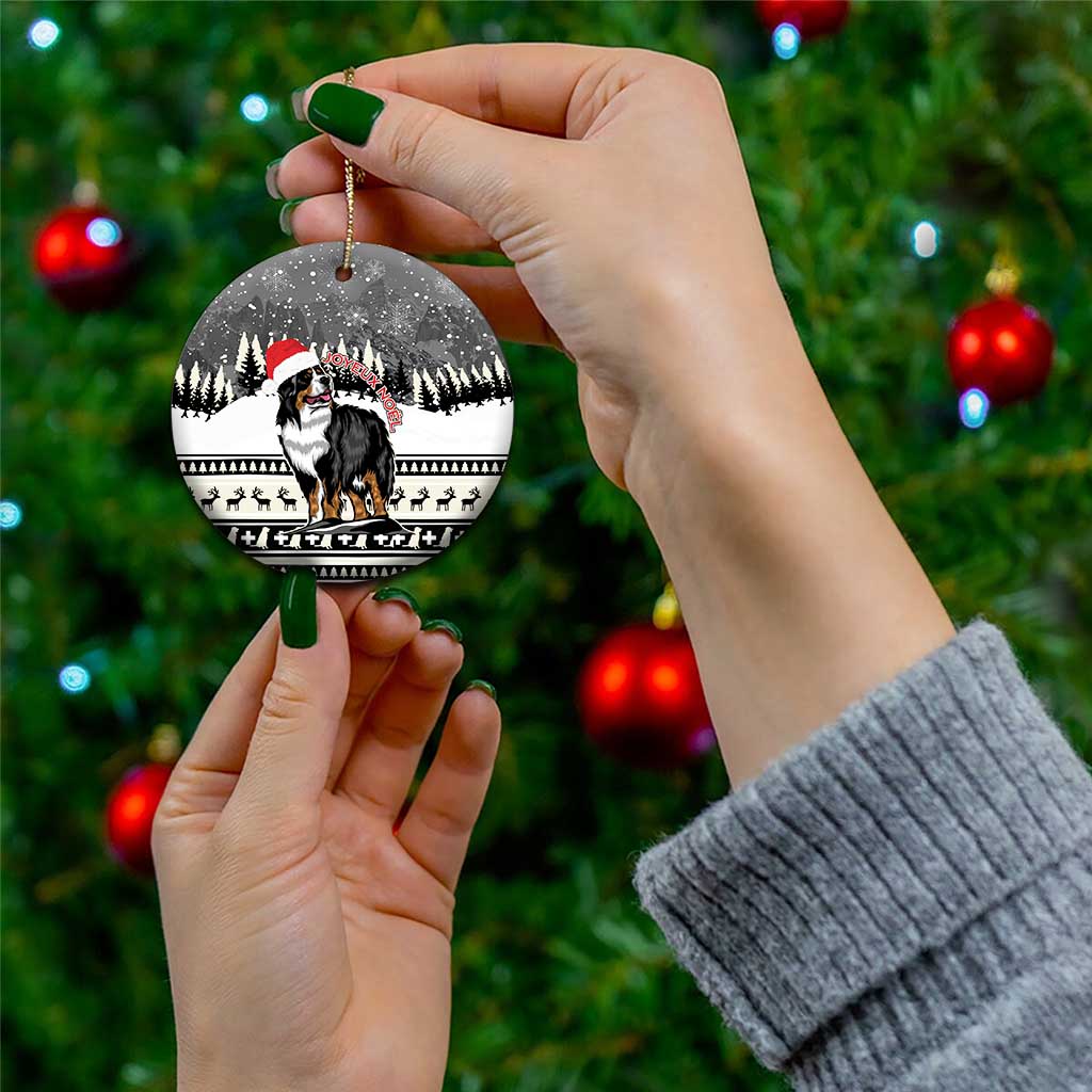 Ceramic round Christmas ornament featuring Bernese mountain dog under a snowy forest scene