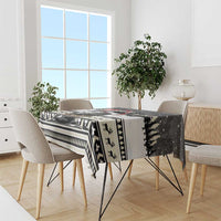 Christmas tablecloth with black, white, and red dog artwork and “Joyeux Noel” text