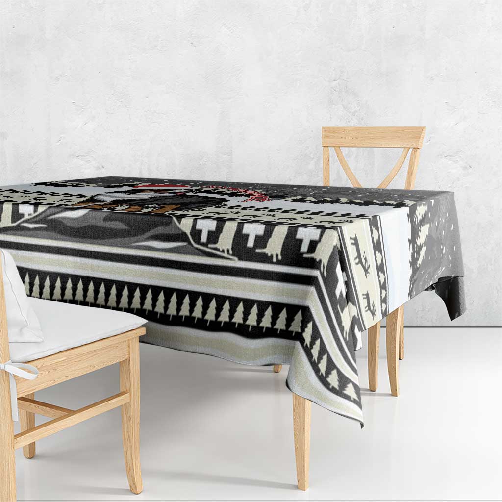 Black and white patterned Christmas tablecloth with geometric border and evergreen motifs