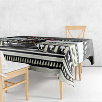 Black and white patterned Christmas tablecloth with geometric border and evergreen motifs