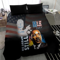Black bedding set with two dark pillows, MLK Day portrait with U.S. stripes
