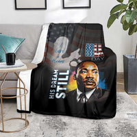 Black MLK Day blanket on sofa with Martin Luther King Jr. portrait and text graphic