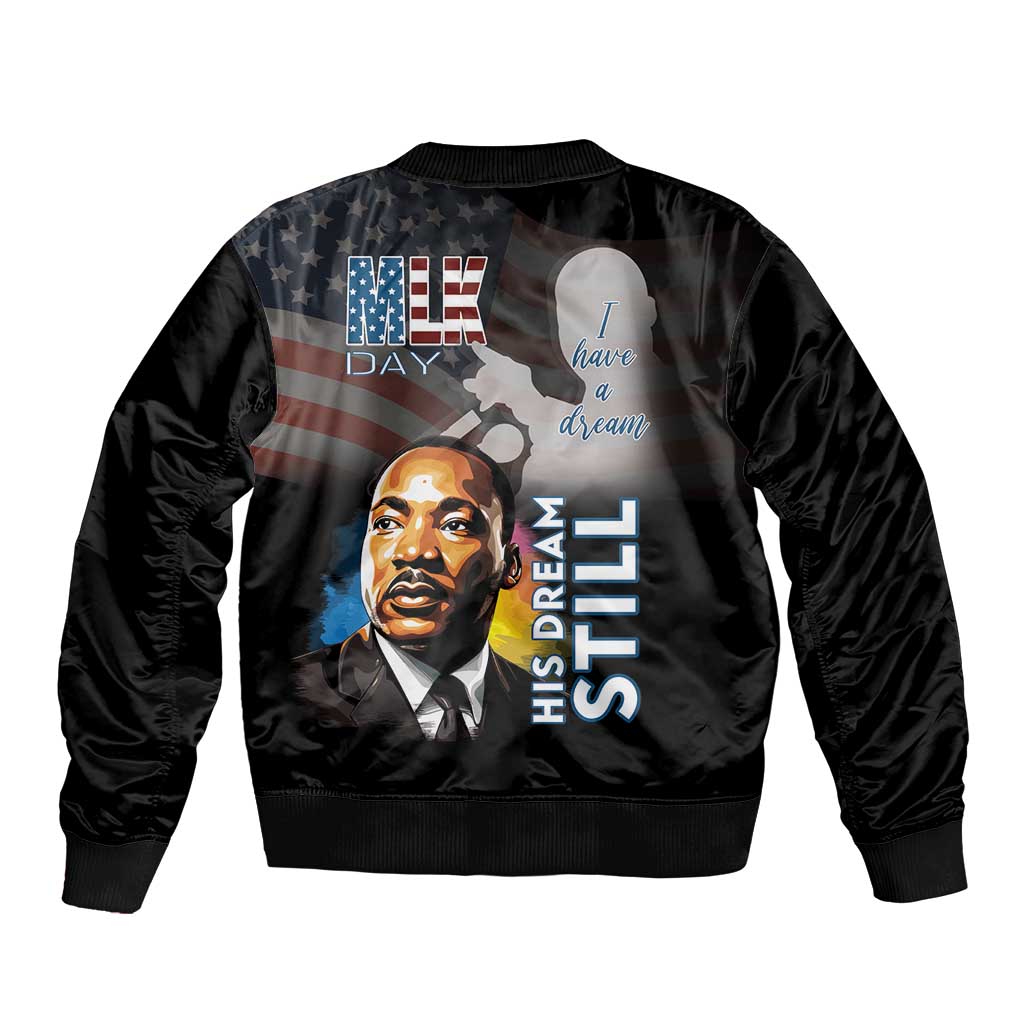 Black unisex bomber jacket with back print, portrait and His Dream Still text