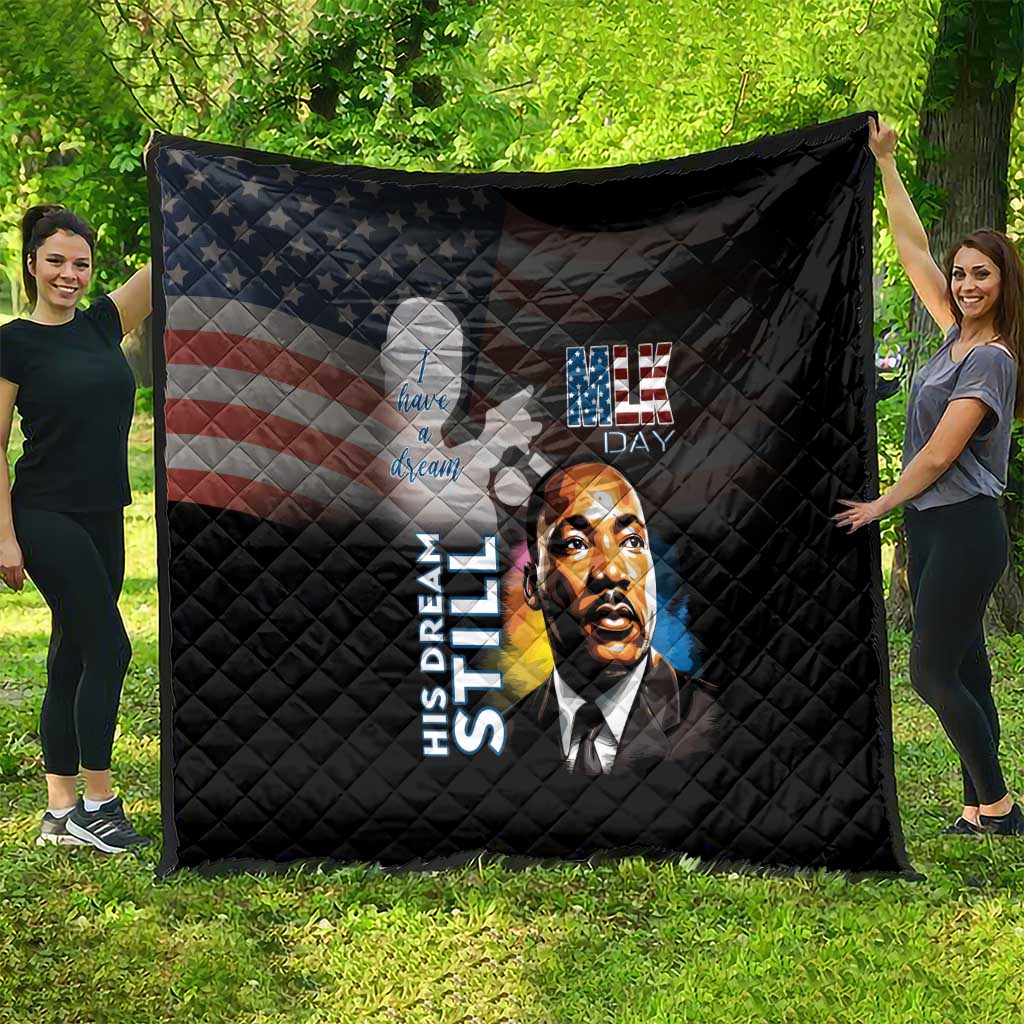 Black quilt laid out outdoors with quilted texture, MLK Day portrait and U.S. stars