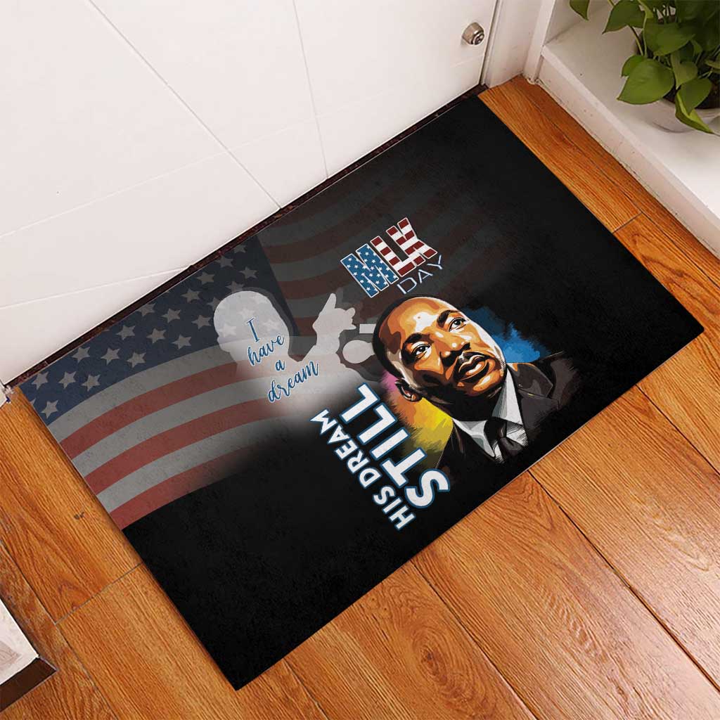 Black rubber doormat featuring MLK portrait, American flag graphic, and patriotic text