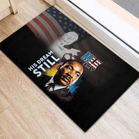 Black rubber doormat with MLK portrait in front of American flag stripes and “His Dream”