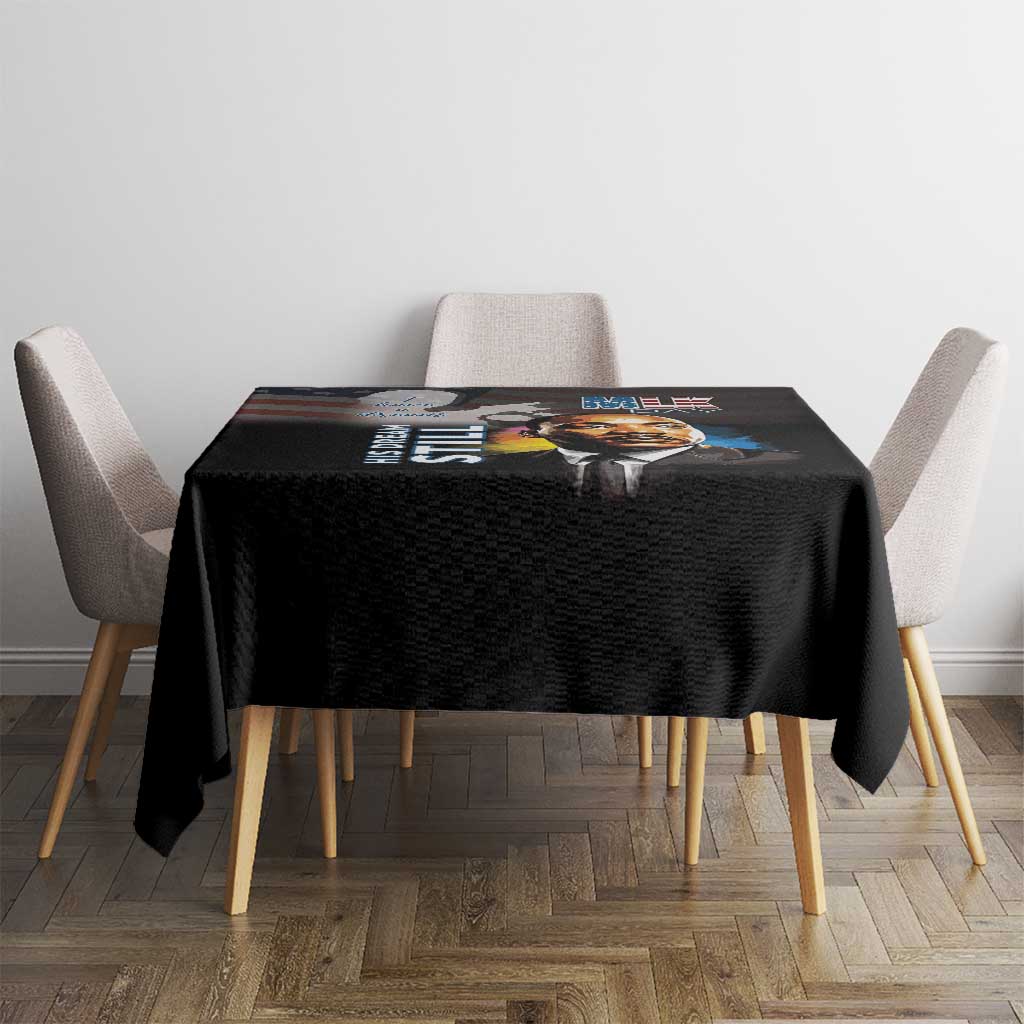 Black tablecloth featuring MLK Day portrait and colorful quote print across tabletop