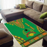 Green dashiki-pattern area rug with black star, red fan shell, and “OUR TEXT”