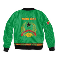 Green bomber jacket back with embroidered crest, star and custom text, black ribbed hem.