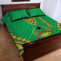 Green quilt bed set with diamond quilting and dashiki border, two pillows on wooden bed