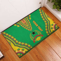 Green rubber doormat with Dashiki pattern border, central star, 'YOUR TEXT' in orange