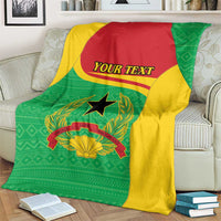 Personalized Guinea-Bissau blanket on armchair in green, yellow, and red with “YOUR TEXT”