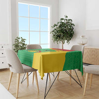 Personalised Guinea-Bissau tablecloth draped on table, green pattern with yellow edge.