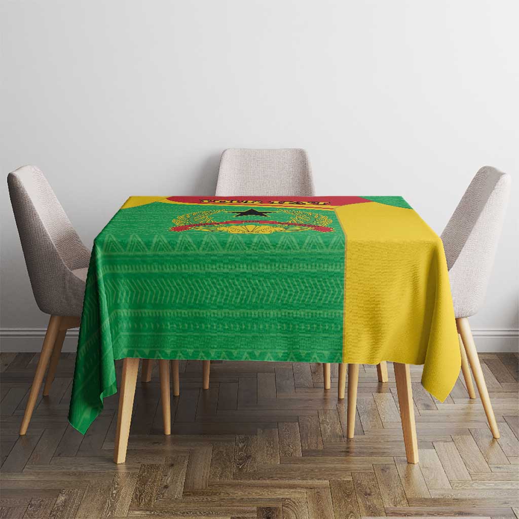 Personalised Guinea-Bissau tablecloth on dining table, green patterned fabric with yellow side.
