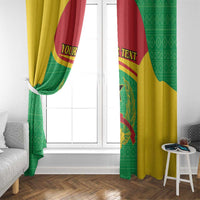 Window with two flag curtains in green, yellow and red, crest and star centered