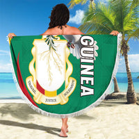Round fringe beach blanket featuring Guinea coat of arms and white pigeon graphic.