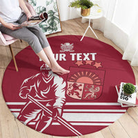 Red round hockey carpet with “YOUR TEXT” and player graphic, shown with seated person