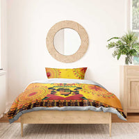 Orange African-pattern duvet bedding set with 'Happy Kwanzaa' banner on bed