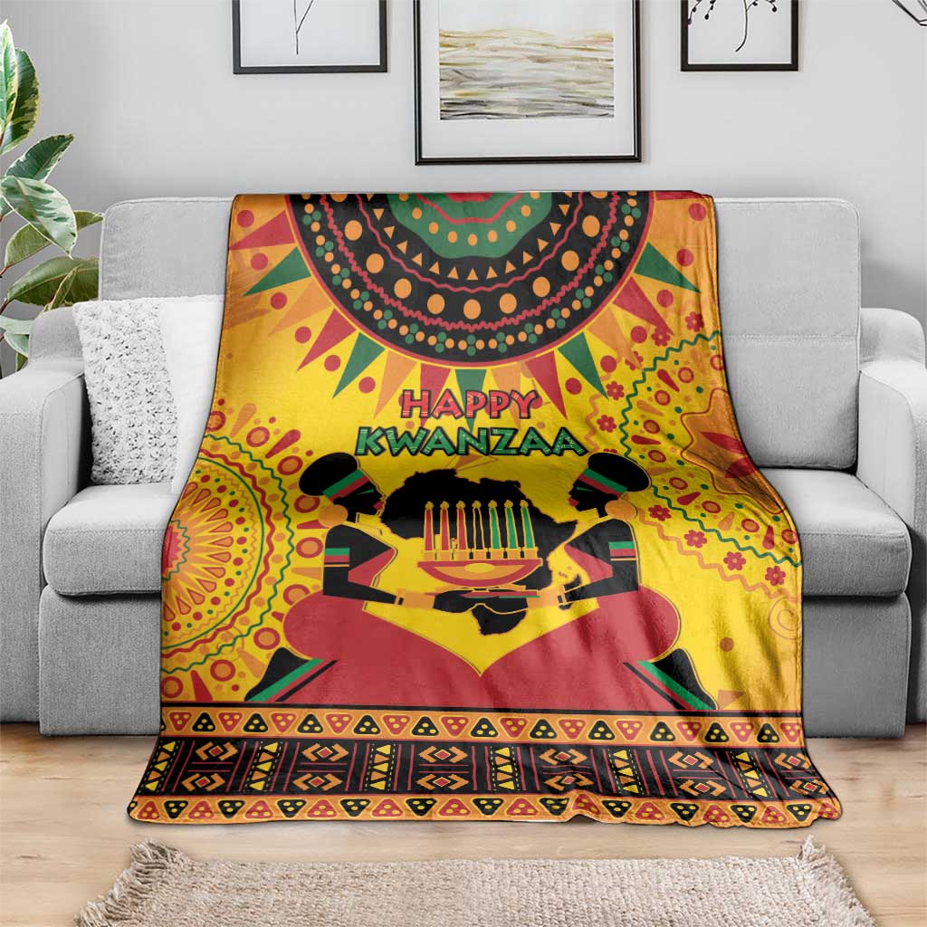 Orange Kwanzaa holiday blanket draped over couch with 'Happy Kwanzaa' design
