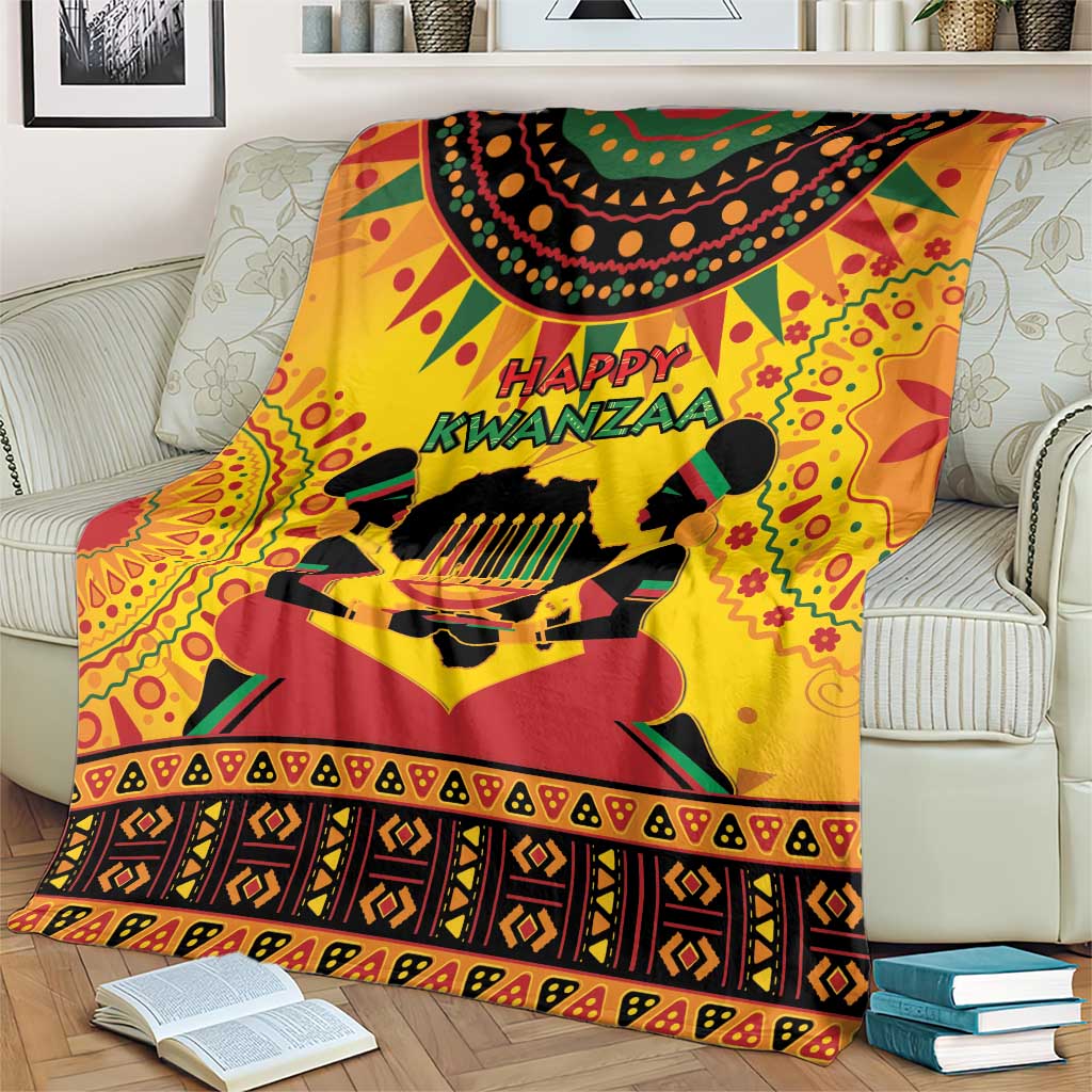 Orange Kwanzaa holiday blanket laid across sofa with 'Happy Kwanzaa' motif