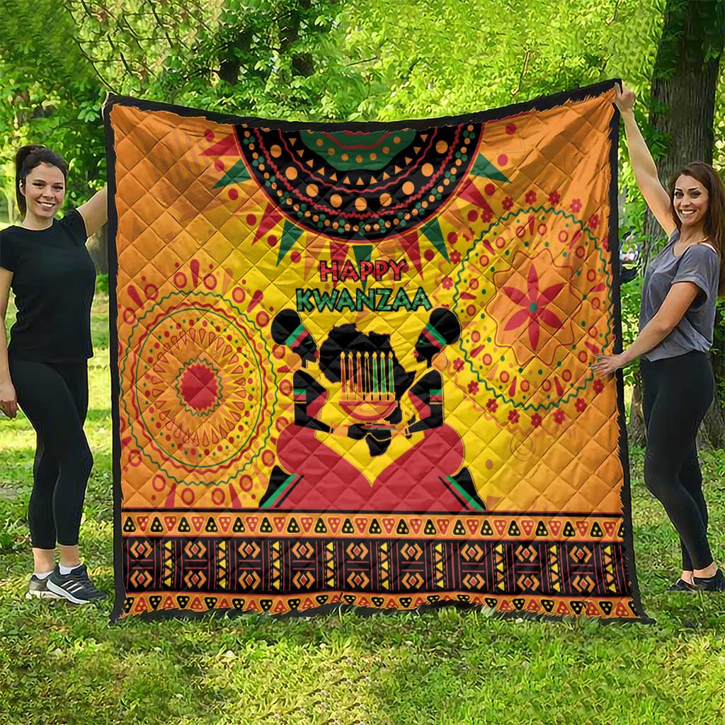 Orange Kwanzaa-themed quilt with Happy Kwanzaa lettering, drum motif, bold patterned trim