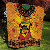 Orange Kwanzaa quilt with Happy Kwanzaa text, central drum figure, decorative circular motifs
