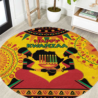 Orange round Kwanzaa carpet with “Happy Kwanzaa” text and African celebratory figures