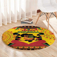 Orange round Kwanzaa carpet with “Happy Kwanzaa” lettering and candleholder centerpiece