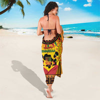 Orange Kwanzaa sarong with Happy Kwanzaa text, drum and dark patterned border