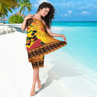 Orange Kwanzaa sarong with geometric border and Happy Kwanzaa drum centerpiece