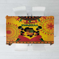 Orange Kwanzaa African-pattern tablecloth with “Happy Kwanzaa” candles and geometric motifs.