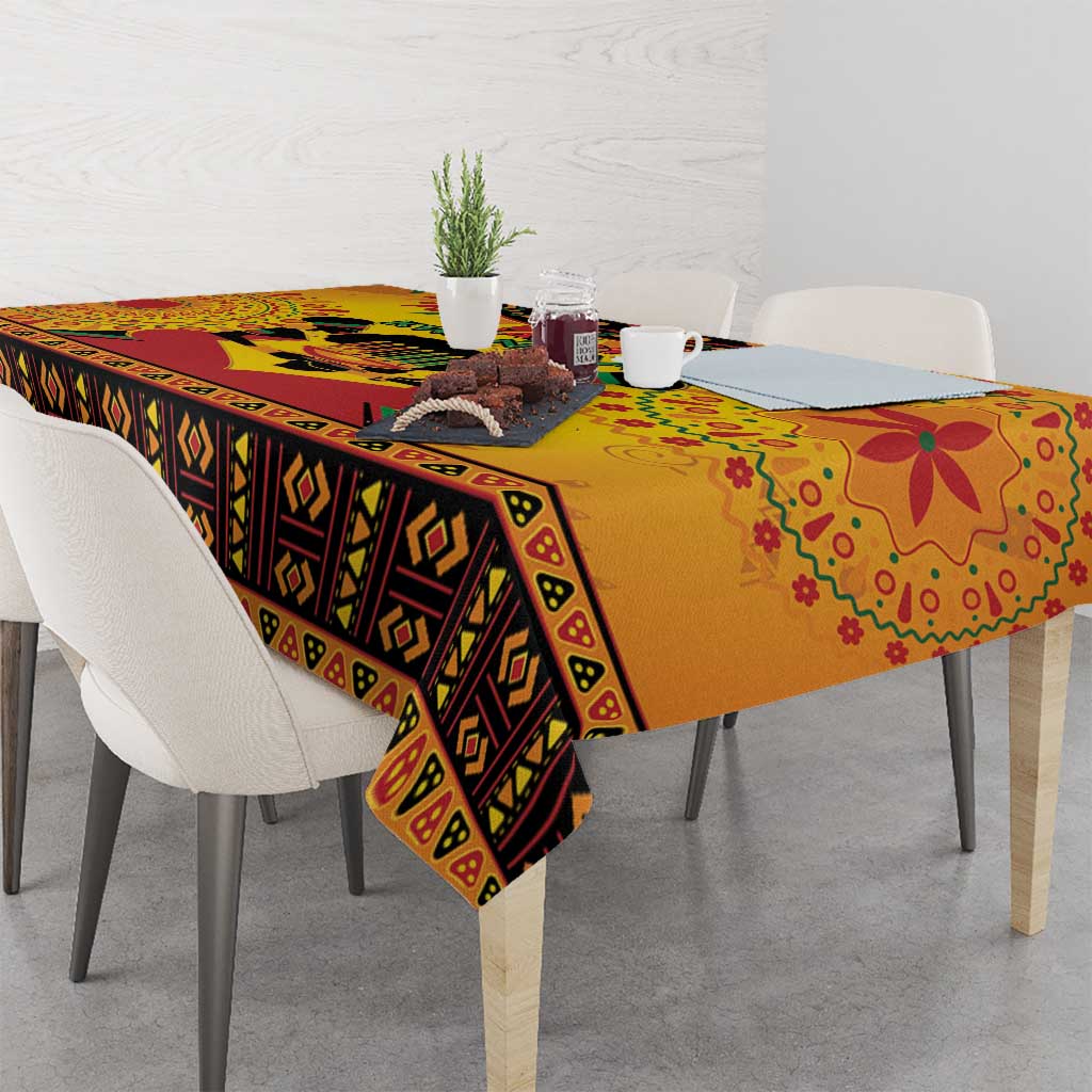 Orange Kwanzaa tablecloth with geometric stripe border and corner drape on dining table.
