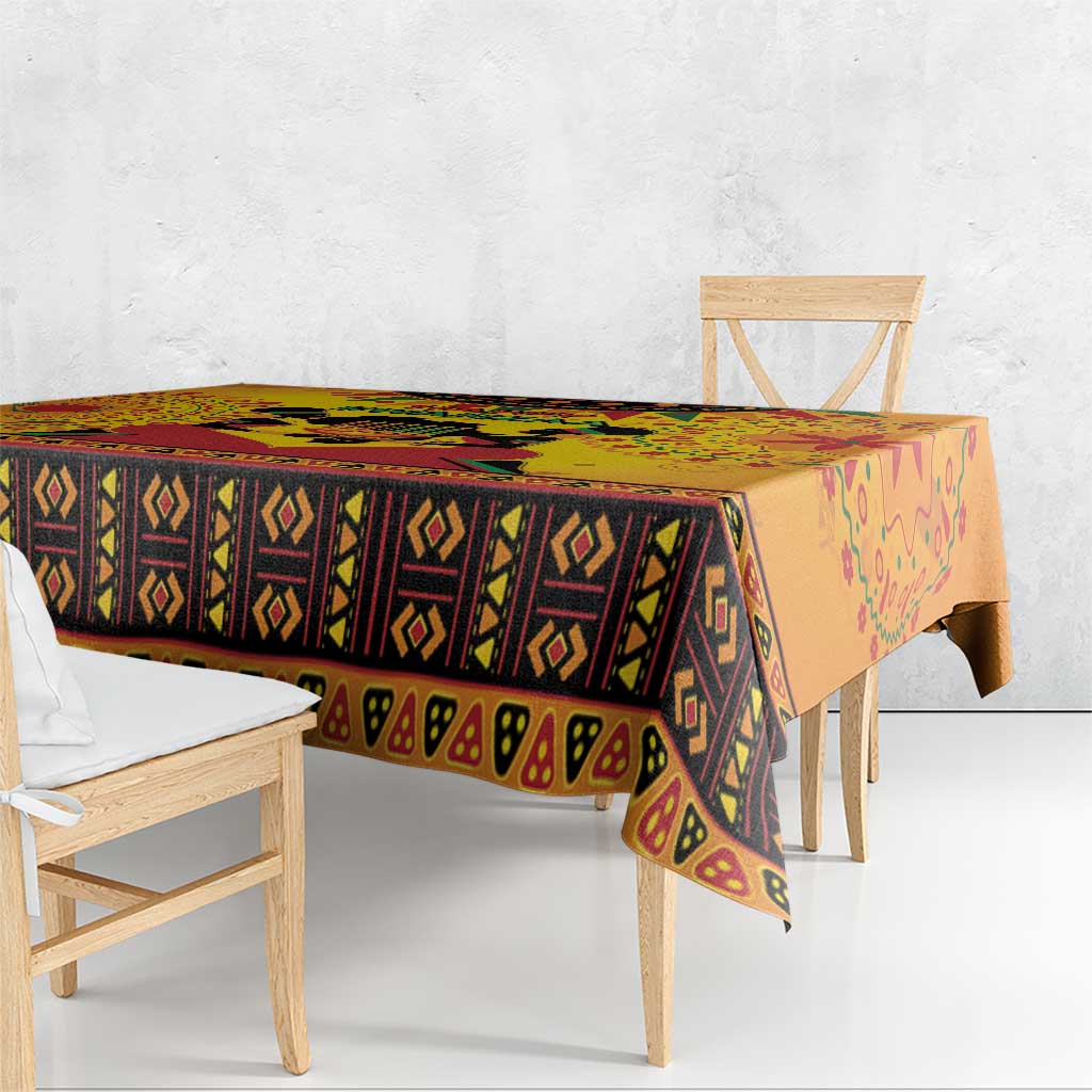 Orange Kwanzaa African-pattern tablecloth with diamond stripe band along the tabletop edge.