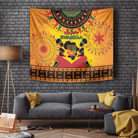 Orange Kwanzaa holiday tapestry with 'Happy Kwanzaa' text and kinara candleholder