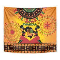 Close-up orange Kwanzaa tapestry with 'Happy Kwanzaa' and kinara candleholder