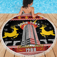 Round beach blanket with fringed edge, black Christmas party design with building and 1988